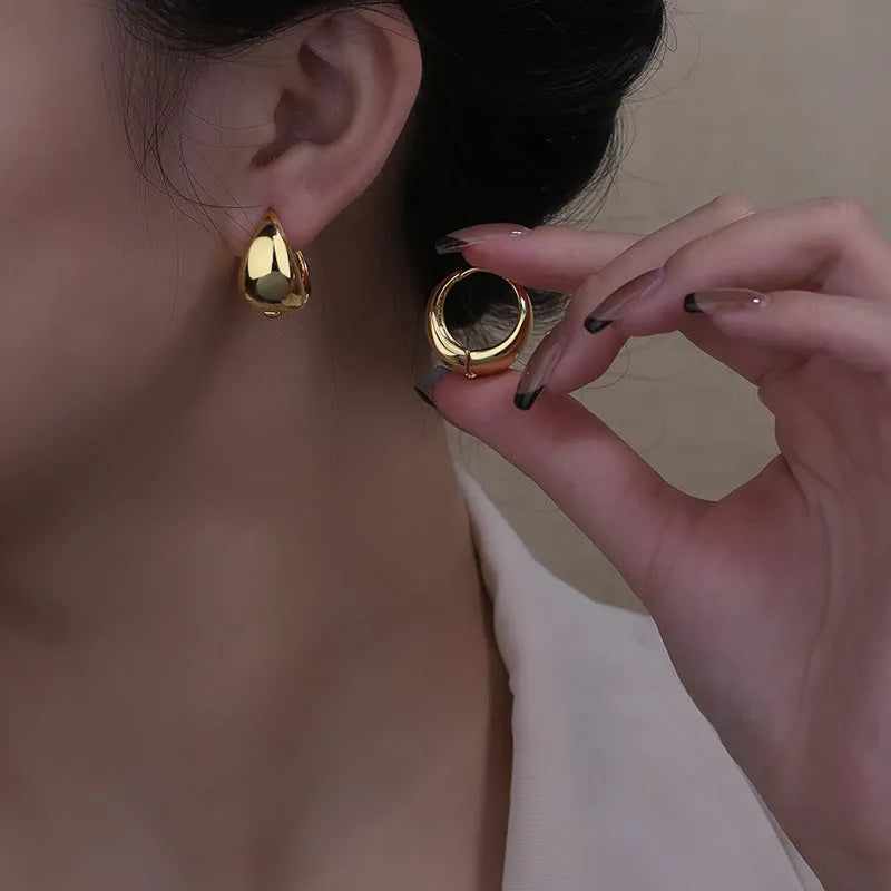 Copper geometric circle ear clips with gold inlay, ellipse and ring shape, shown in gold or white colour options.