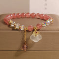 Women's natural crystal bracelet with strawberry quartz and white agate beads featuring auspicious cloud design