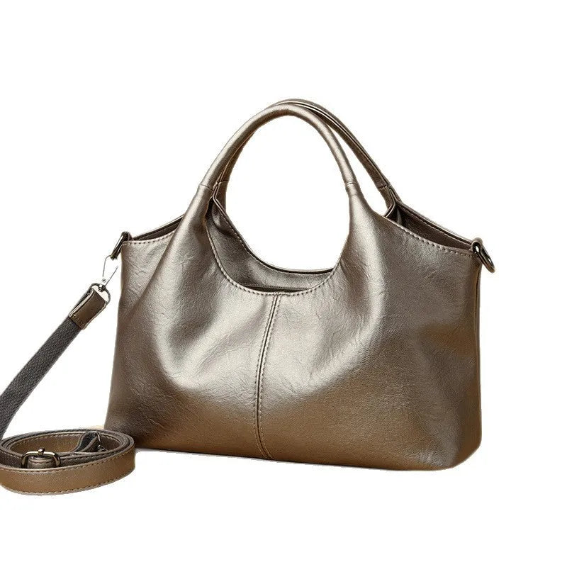 Women's soft genuine leather cross-body bag in beige colour with large capacity.