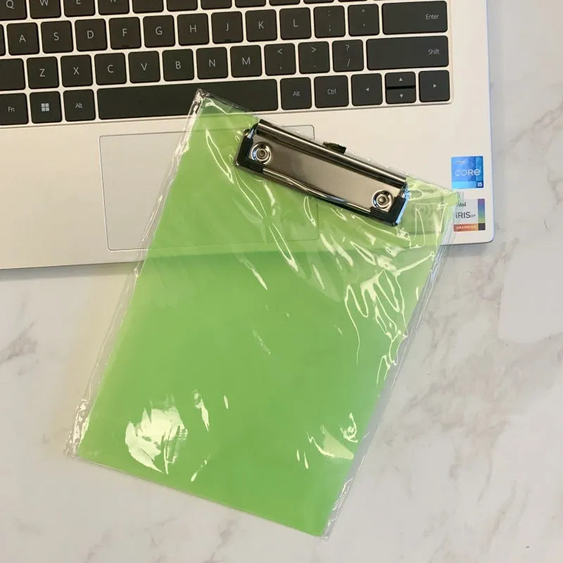 A4 transparent plate holder writing board with metal clip, shown in blue on a desk.