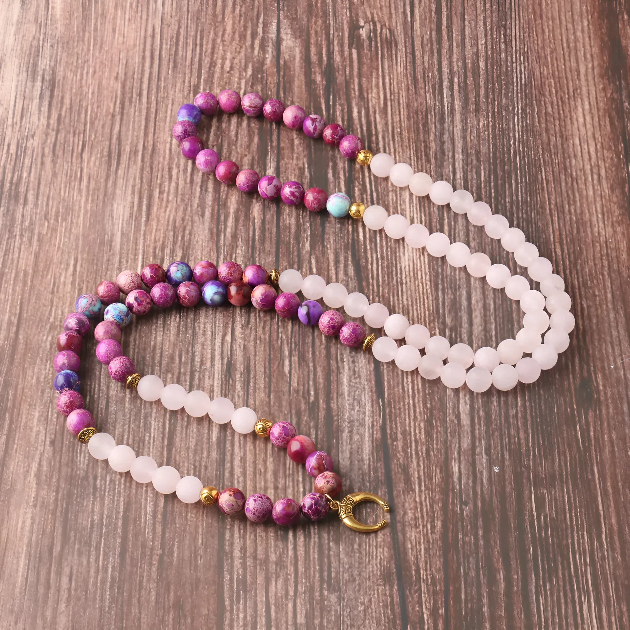 Close-up of a pink emperor stone crystal bead pendant on a necklace chain for casual wear.
