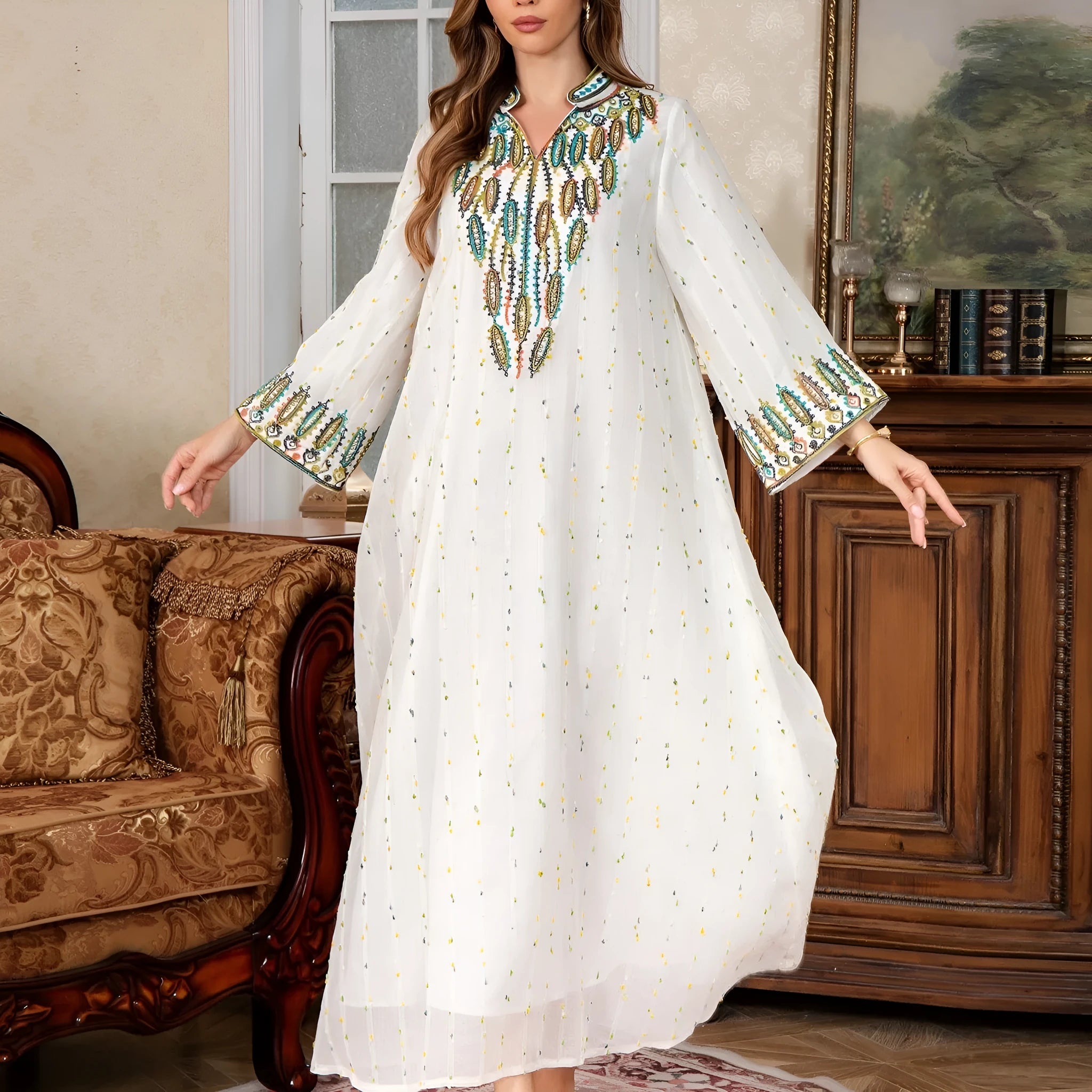 White polyester Arabic robe with long sleeves and full-length skirt on hanger