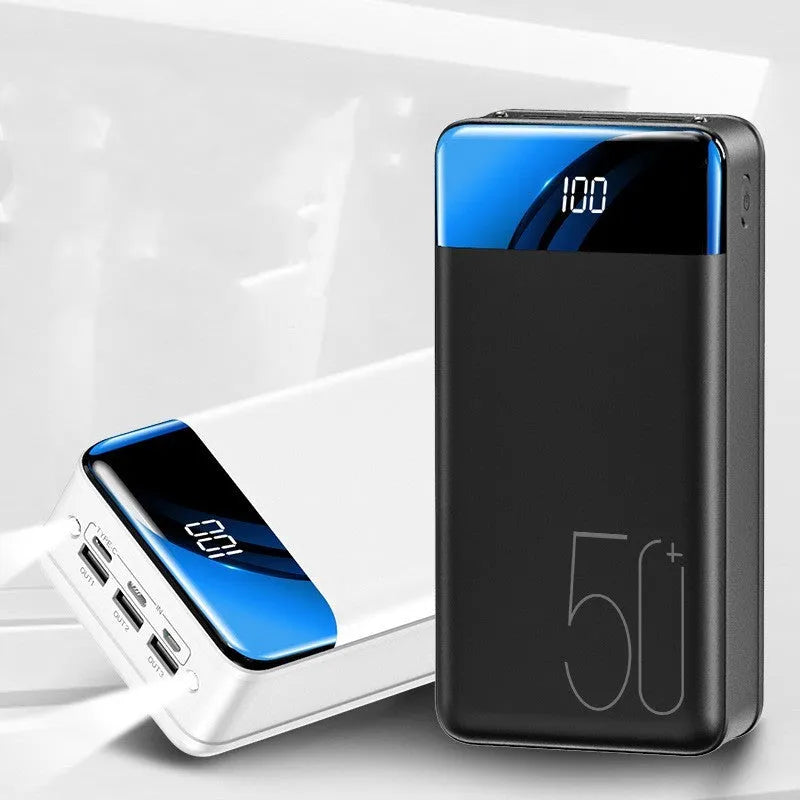 Black and white large 50000mAh power bank with three USB ports showing size scale