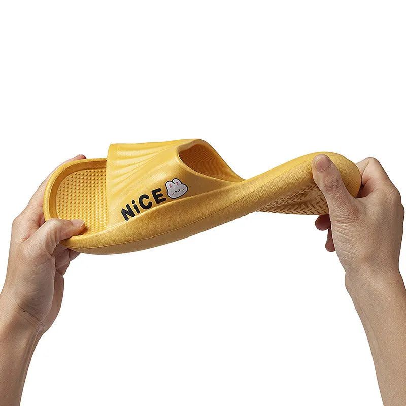 Pair of lightweight EVA flip-flop slippers with a minimalist cartoon pattern and non-slip soles.
