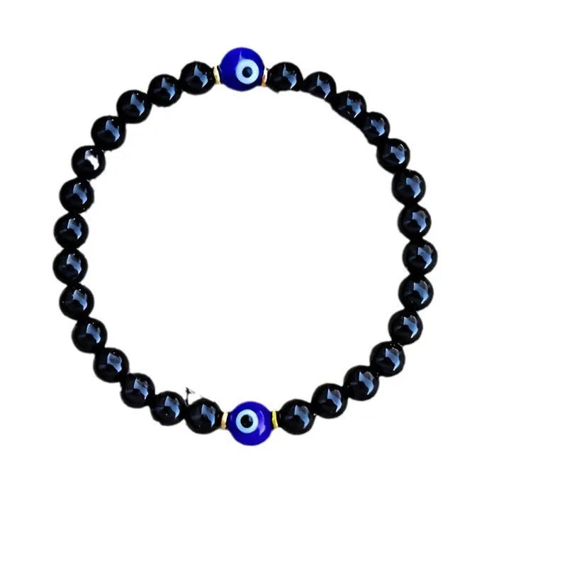 Men's black beaded bracelet with 8mm devil's eye beads and 6mm black beads in a geometric design.