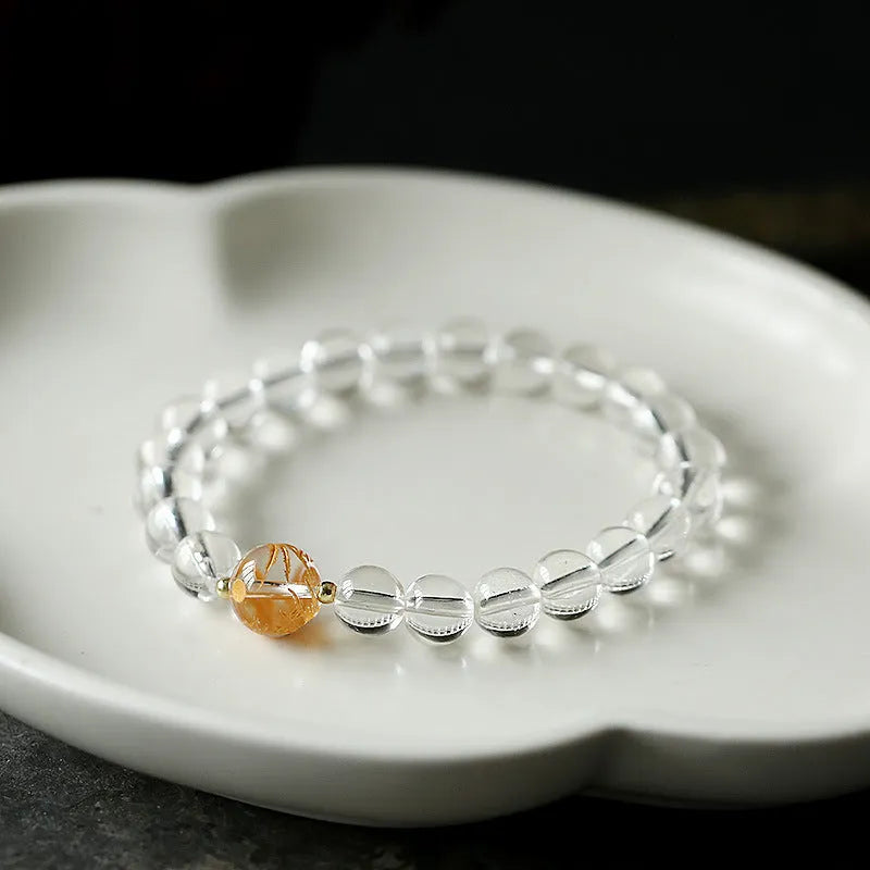 Geometric obsidian white crystal bracelet with black agate beads and golden dragon charm on wrist