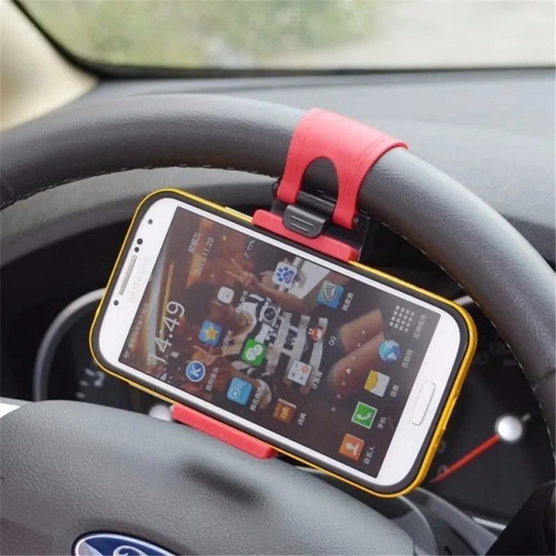 Black steering wheel phone clip mount holding smartphone with soft silicone padding visible