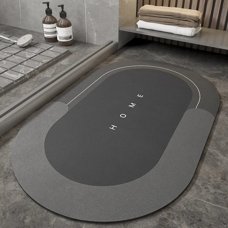 Blended fibre machine woven bathroom floor mat in blue, shown in an oval shape on a tiled floor.