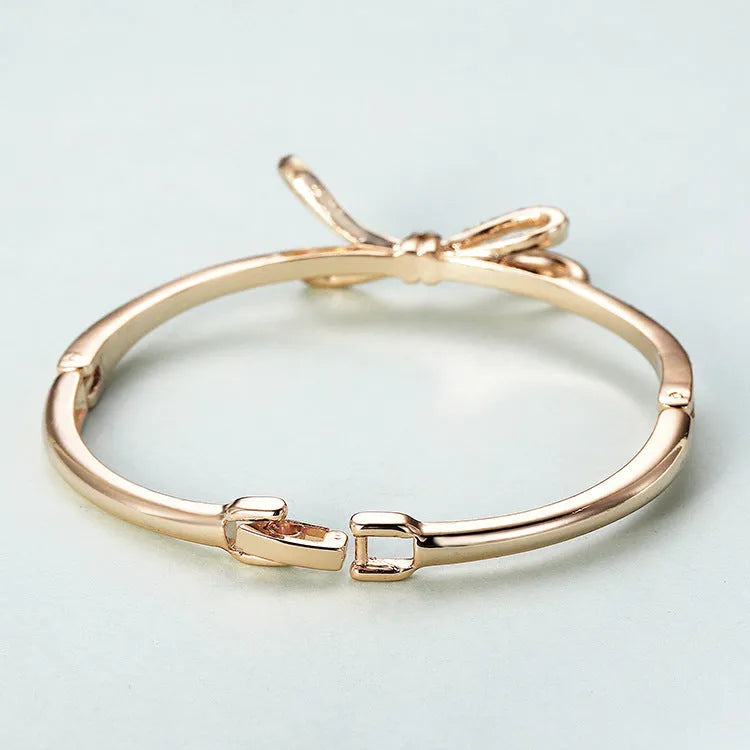 Rose gold electroplated copper women's bracelet with bow and diamond accents