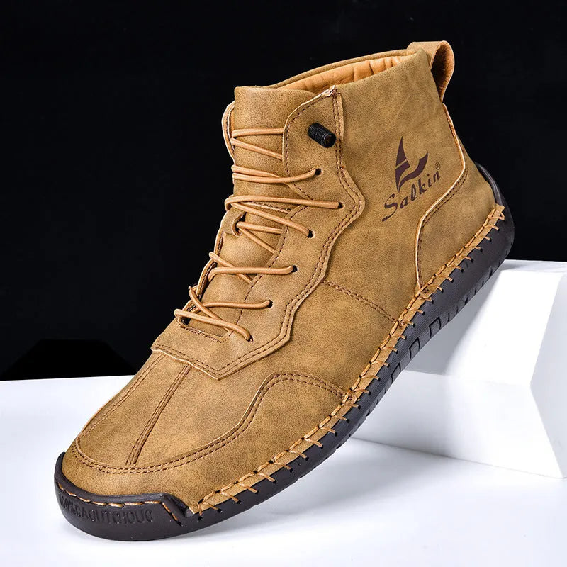 Men's beige retro-style mid-calf boots with an elastic band and flat rubber sole on a white background.