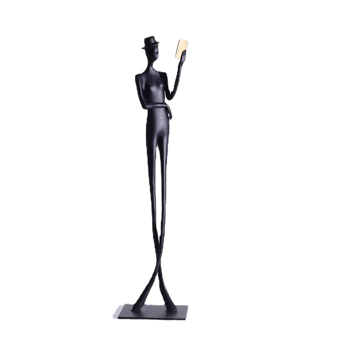 Black metal cast aluminium reading woman sculpture on desk, modern minimalist style