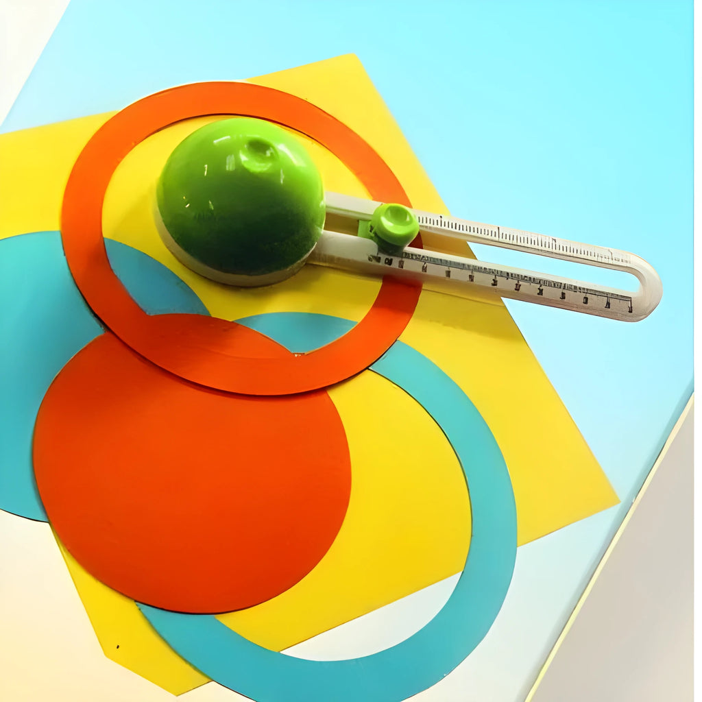 Plastic round paper cutter in orange or green colour on a colour box, showing A3 cutting size.