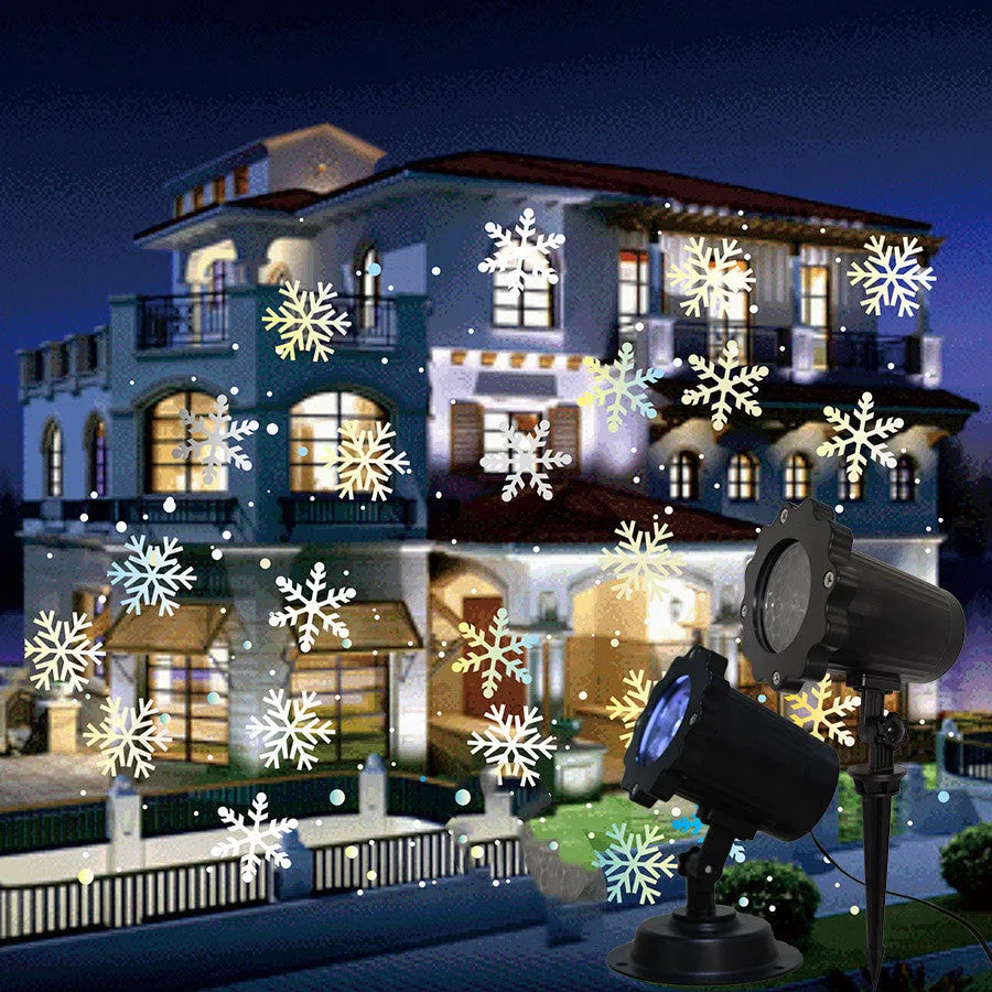 LED Christmas snowflake laser projector with white moving patterns on a dark garden wall at night