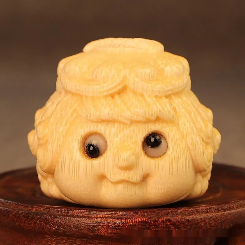 Solid bamboo carving of a cute Golden Toad Princess ornament on a neutral background.