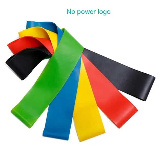 Set of five coloured TPE yoga tension resistance bands with force marks, laid flat showing different thicknesses.