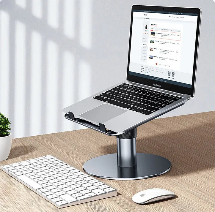 Silver adjustable car laptop stand with rotating base extended on a car seat.