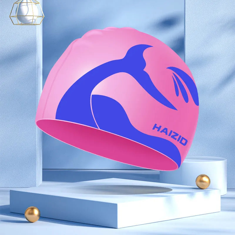 Adult unisex silicone swim cap with whale tail pattern and built-in ear protectors in four colours.