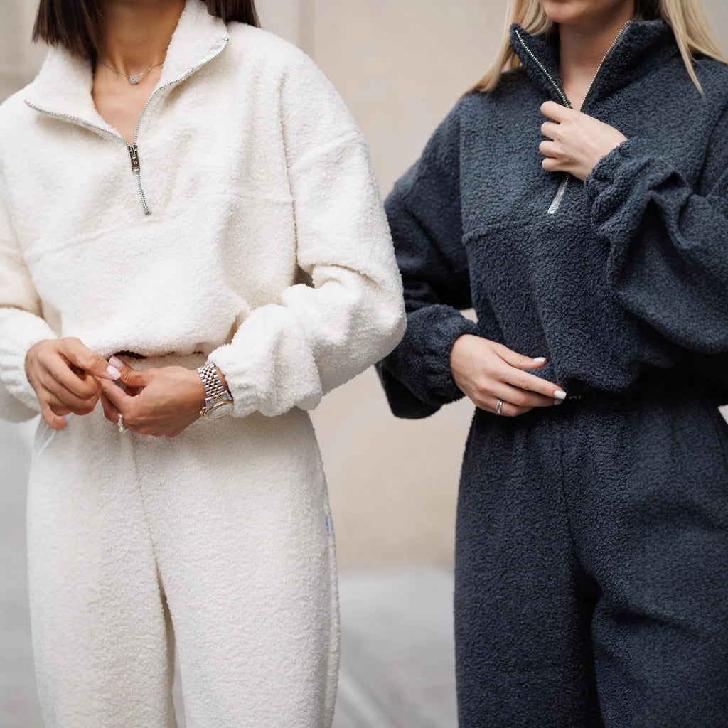 Polar fleece two-piece suit with long sleeve half pull top and trousers in solid grey or white, sizes S M L.