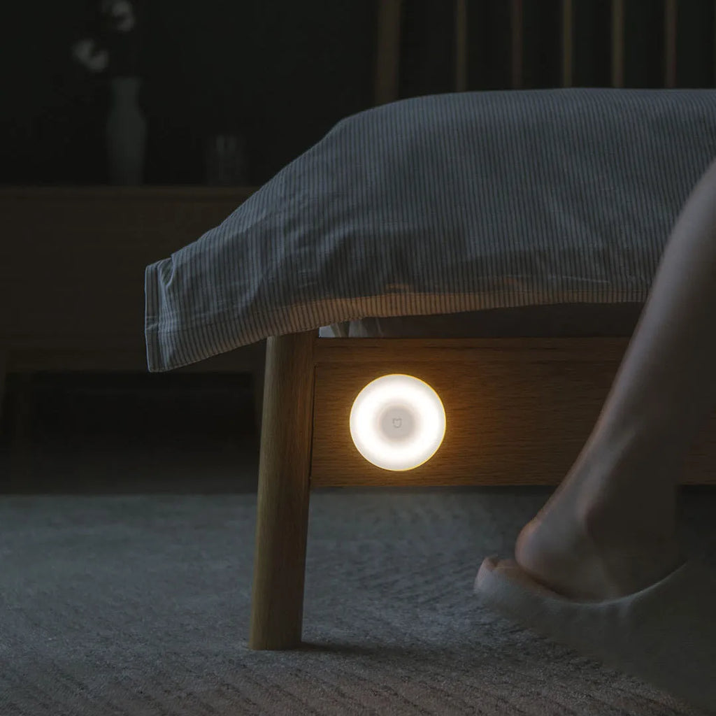 White Mijia Night Light 2 Bluetooth bedside lamp with human body induction on wooden table