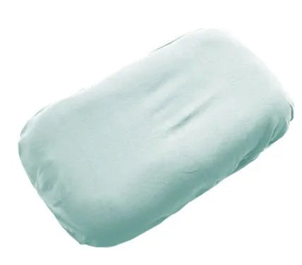 Beige portable cotton baby nest crib for newborns on a neutral background
