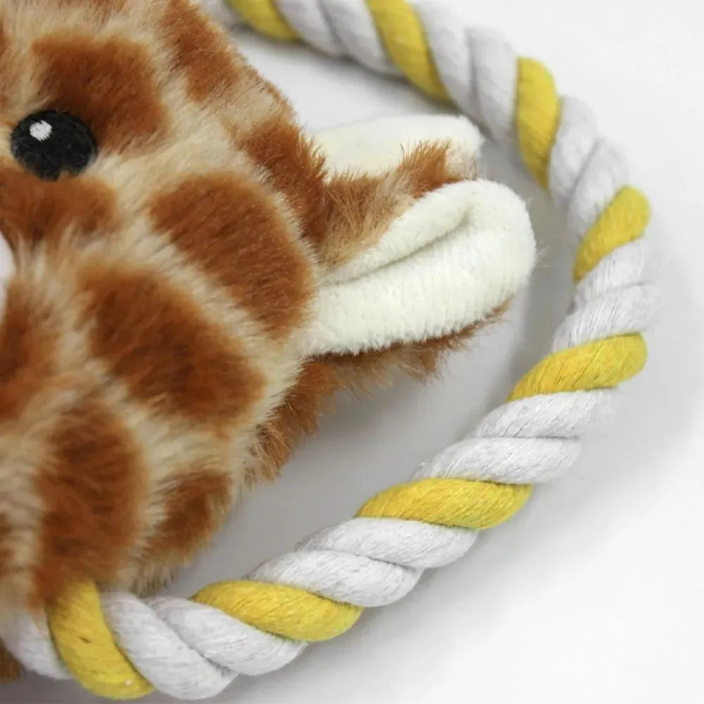 Plush dog toy shaped like zebra with rope and squeaker on white background