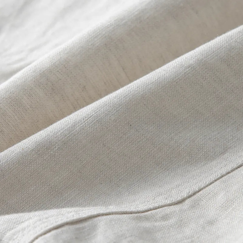 Men's casual linen suit jacket in a solid colour on a hanger, showing long sleeves and a relaxed fit.