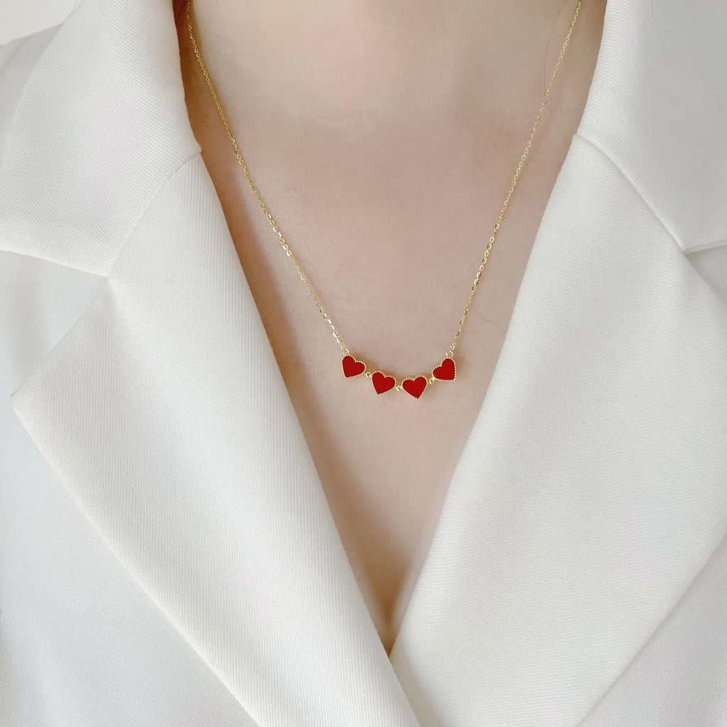 Red magnetic four-leaf clover pendant necklace with gold-plated copper on titanium steel O-link chain