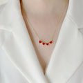 Red magnetic four-leaf clover pendant necklace with gold-plated copper on titanium steel O-link chain