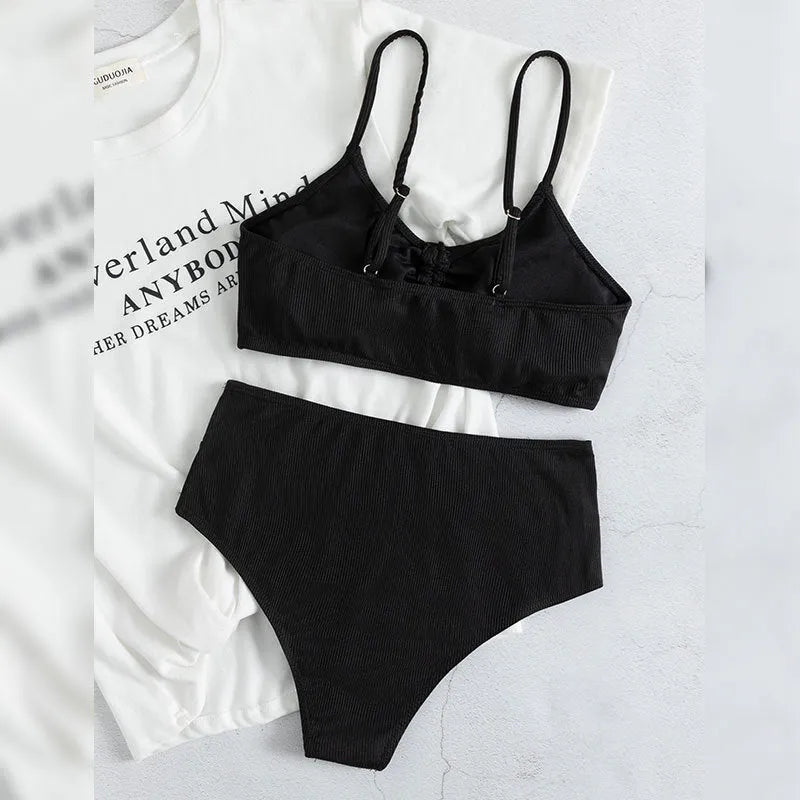 Black women's swimsuit with high waist bottoms and sleeveless top on mannequin