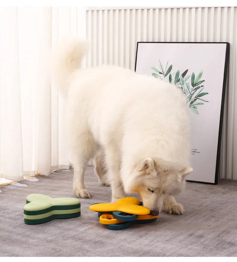 Green and yellow dog puzzle toy with bone covers and rotatable treat dispenser on non-slip base