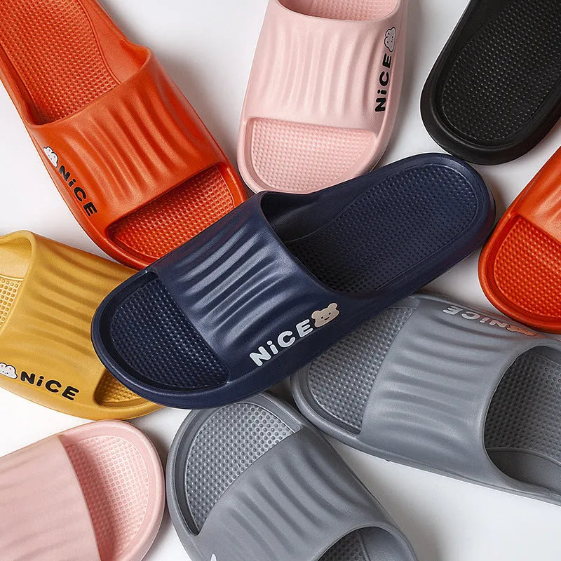 Pair of lightweight EVA flip-flop slippers with a minimalist cartoon pattern and non-slip soles.