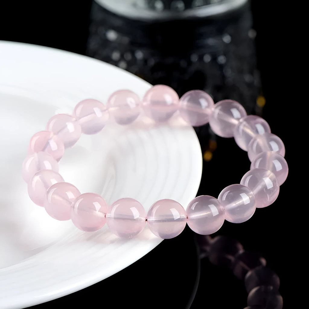 Polished natural crystal bracelet with round pink beads in starlight style, showing colour and size options.