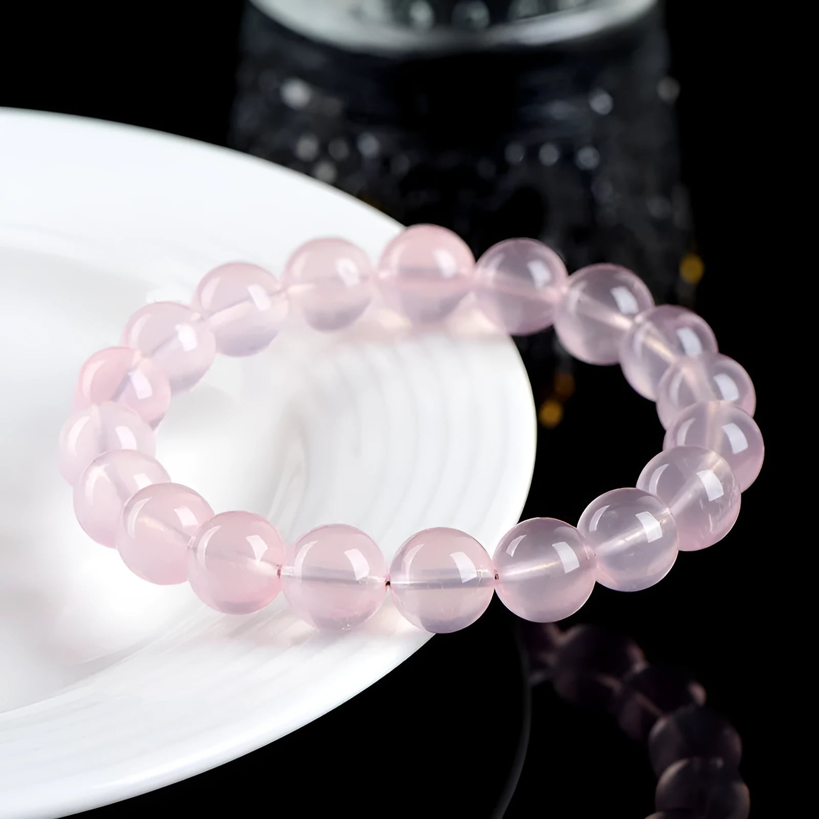 Polished natural crystal bracelet with round pink beads in starlight style, showing colour and size options.