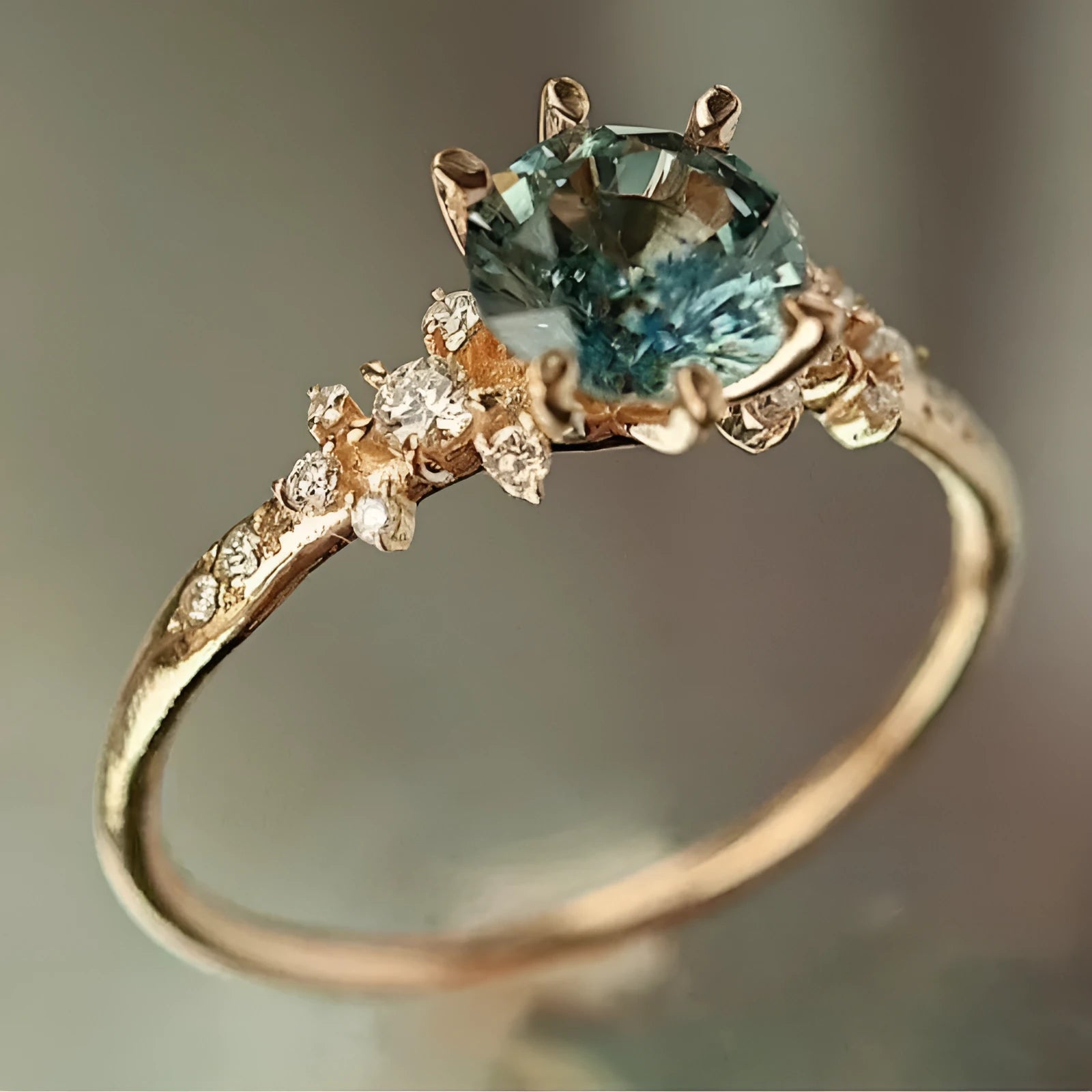 Gold plated geometric ring with claw inlay zircon stones and a chamfered square pattern.
