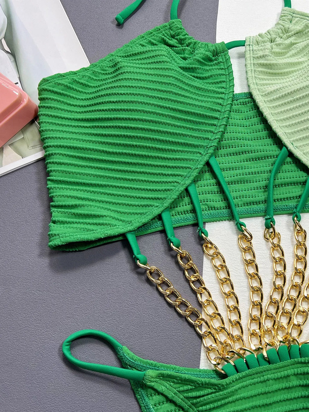 Green solid colour women's one-piece swimsuit on a mannequin