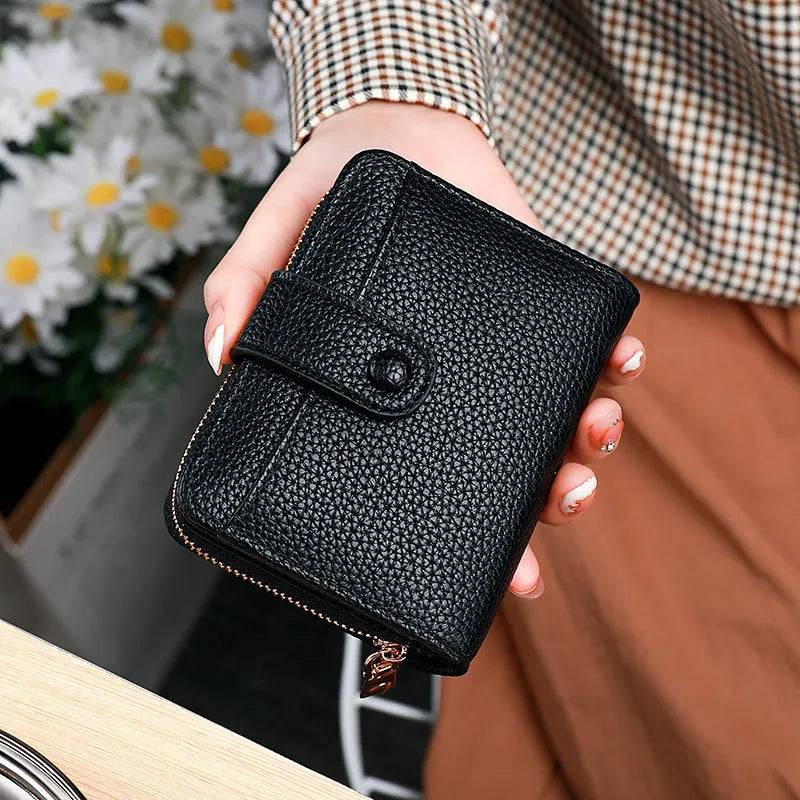 Women's solid colour short wallet with lychee pattern and sewing thread detail in multiple colours.