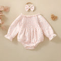Pink infant cotton long sleeve romper with smocking and print on front for newborn baby girl