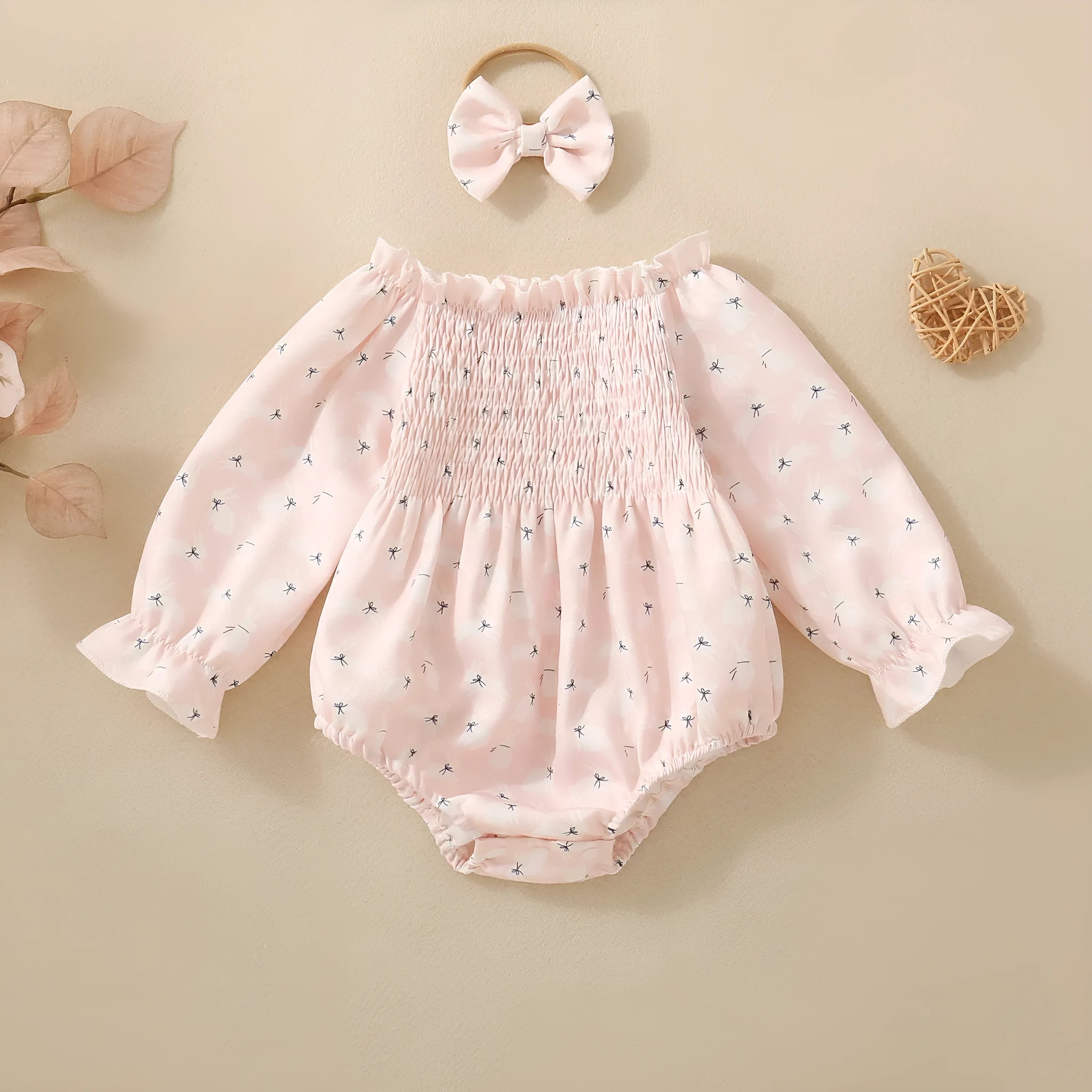 Pink infant cotton long sleeve romper with smocking and print on front for newborn baby girl