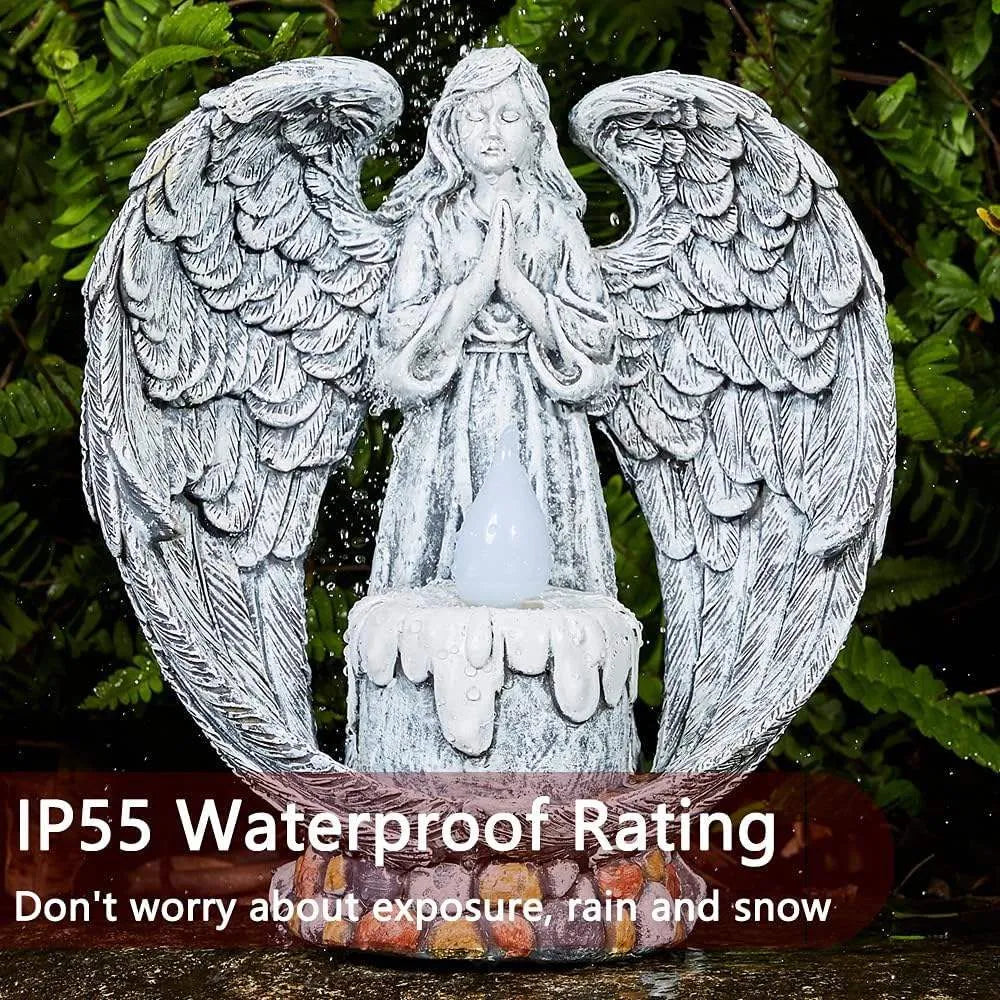 Grey resin praying angel solar garden statue on grass with wings and hands clasped