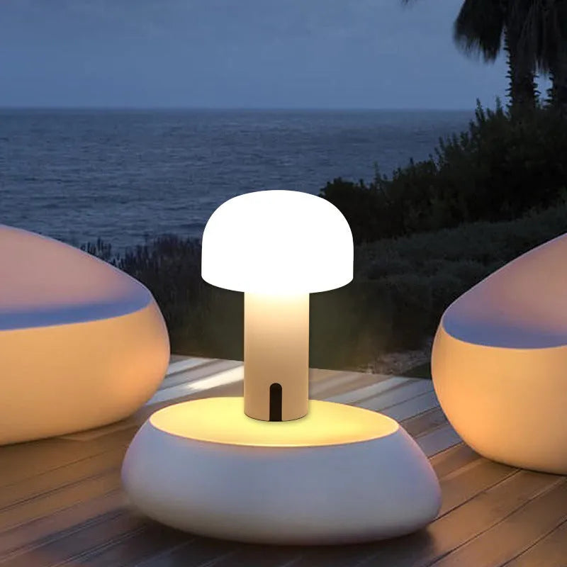 Decorative LED mushroom night light in green with warm white glow on a bedside table