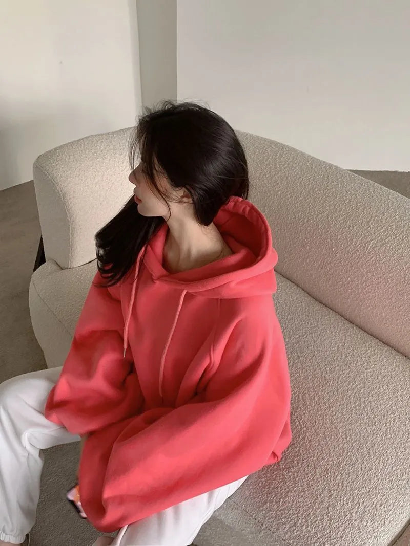 Watermelon red mulberry silk sleeveless hooded sweater on hanger showing loose fit and hood detail