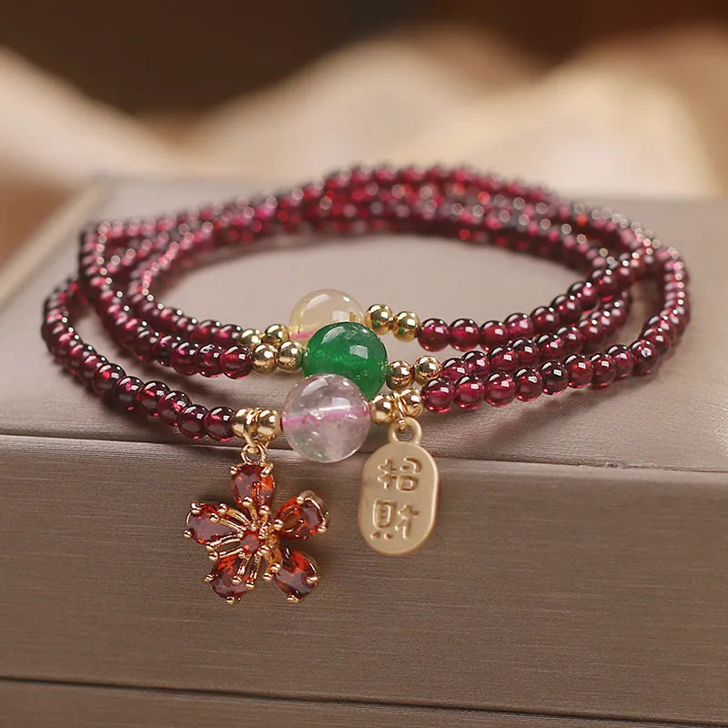 Natural crystal pomegranate red cherry blossom bracelet with sequins on wrist