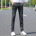Men's slim fit skinny tapered pants with mid waist and zip fly, shown in blue, grey and black colour options