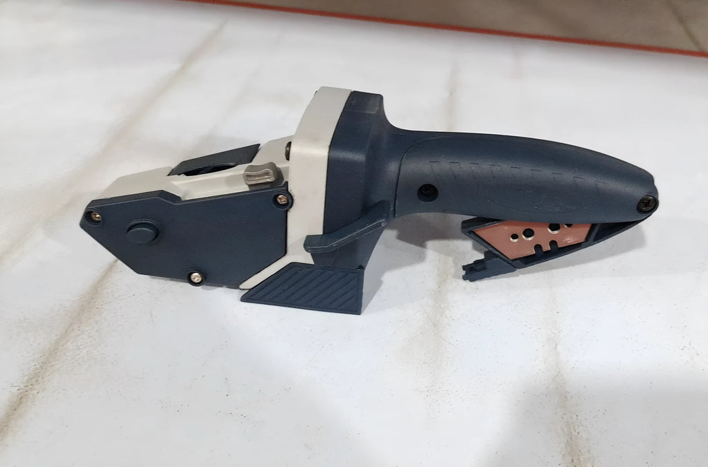 Blue multifunctional woodworking cutter with a one-press lock mechanism and scale for cutting boards.