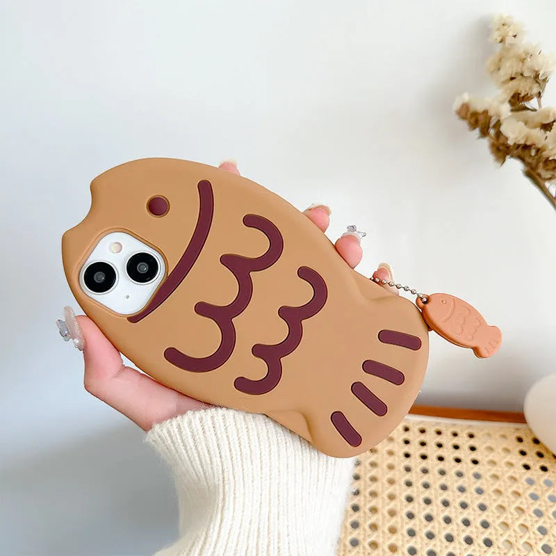 Brown silicone phone case with 3D taiyaki design and hanging ornament for iPhone.