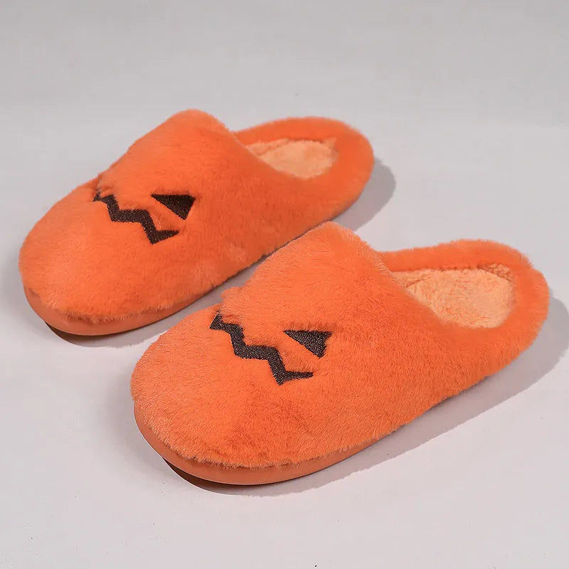 Orange Halloween pumpkin slippers with coral velvet upper and plush lining on a non-slip PVC sole.