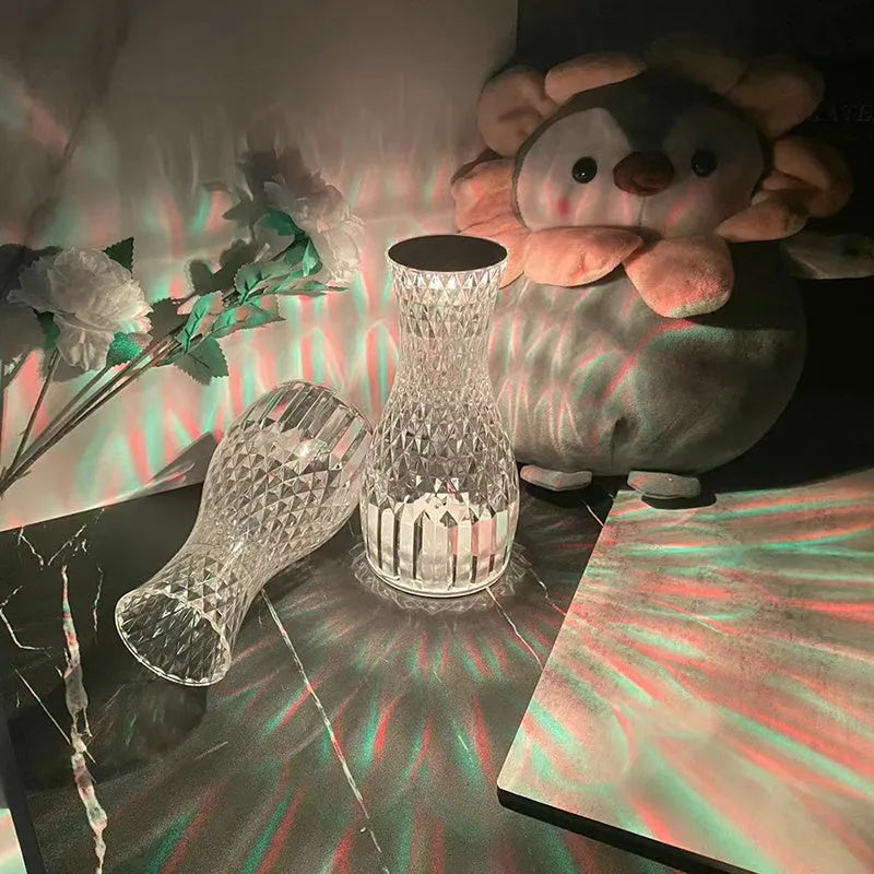 Crystal vase-shaped table lamp with remote control on wooden bedside table