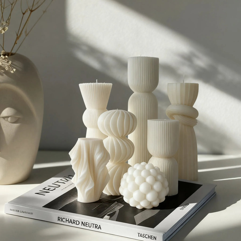 White cylindrical soy wax aromatherapy candle with geometric spherical shape on a table