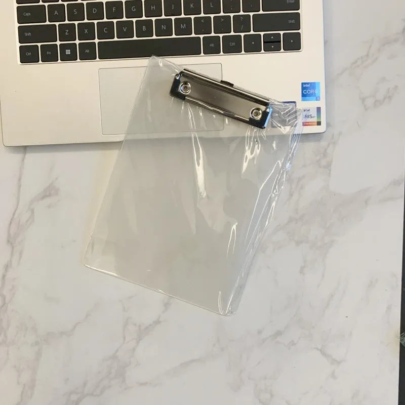 A4 transparent plate holder writing board with metal clip, shown in blue on a desk.