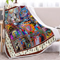 Multicoloured cat themed Sherpa fleece blanket 130x150cm with hemmed edges on a sofa